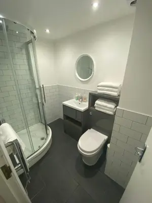 a bathroom with a shower and a toilet and a sink at Eleanor Rigby apts Stanley Street in Liverpool