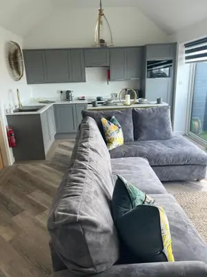 a living room with a couch and a kitchen at Beach View Apartment with balcony and sea view - pet friendly in Cleveleys