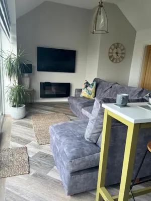 a living room with a couch and a table at Beach View Apartment with balcony and sea view - pet friendly in Cleveleys