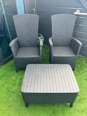 two chairs and a bench sitting on the grass at Beach View Apartment with balcony and sea view - pet friendly in Cleveleys