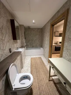 a bathroom with a toilet and a sink and a tub at Beautiful City Centre Apartment in Liverpool