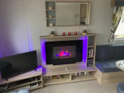 a living room with a flat screen tv and a couch at Blackpool Static Caravan Marton Mere in Blackpool