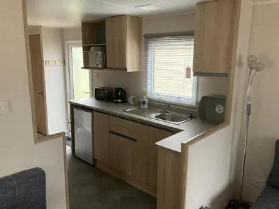 a small kitchen with a sink and a window at Blackpool Static Caravan Marton Mere in Blackpool