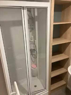 a shower with a glass door in a bathroom at Blackpool Static Caravan Marton Mere in Blackpool
