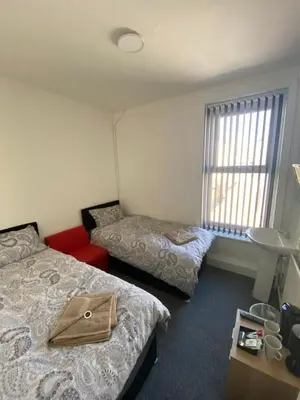 a hotel room with two beds and a window at The Honley hotel in Blackpool