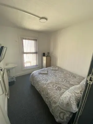 a bedroom with a bed in a room with a window at The Honley hotel in Blackpool