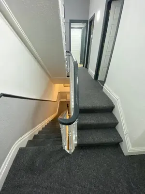 a staircase in a building with a blue hand rail at The Honley hotel in Blackpool
