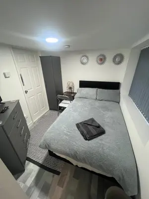 a bedroom with a large bed and a table at The Honley hotel in Blackpool
