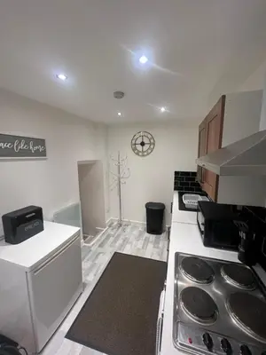 a kitchen with a stove top oven in a room at The Honley hotel in Blackpool