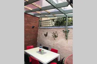 a dining room with a white table and red chairs at Langan's Blackpool Holiday Let in Blackpool