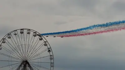 a group of planes flying in formation with red white and blue smoke at Coast Accommodation Station Road Apartments in Blackpool