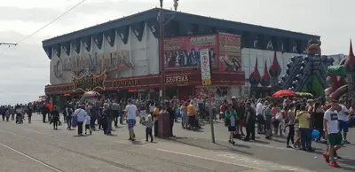 a crowd of people standing in front of a building at Coast Accommodation Station Road Apartments in Blackpool