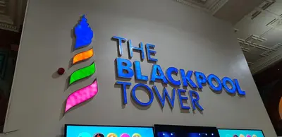 a sign for the blackpool tower on a wall at Coast Accommodation Station Road Apartments in Blackpool