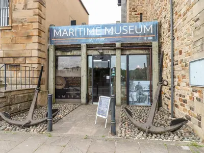 a museum with two large anchors in front of a building at 25 St Georges Quay in Lancaster