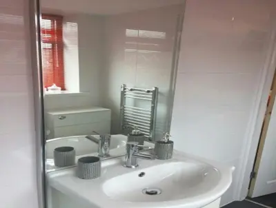 a white bathroom with a sink and a mirror at The Beaucliffe Hotel in Blackpool