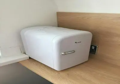 a white refrigerator sitting on top of a wooden shelf at The Beaucliffe Hotel in Blackpool