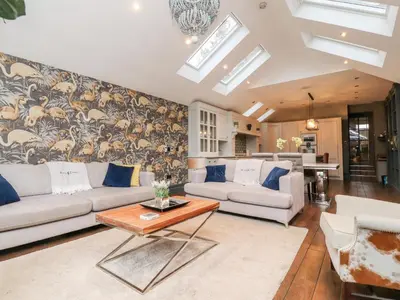 a living room with a couch and a table at Westwood House in Lytham St Annes
