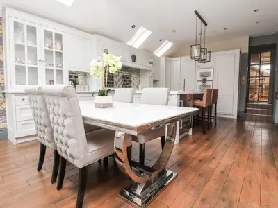 a kitchen and dining room with a table and chairs at Westwood House in Lytham St Annes