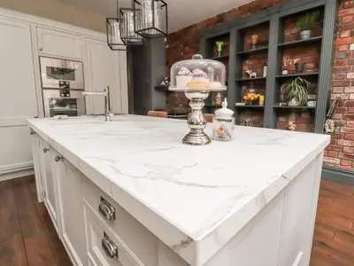 a kitchen with a white counter and a sink at Westwood House in Lytham St Annes