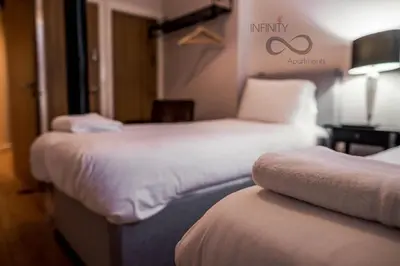 a hotel room with two beds and a sign on the wall at Contractor Bookers Liverpool City Centre in Liverpool