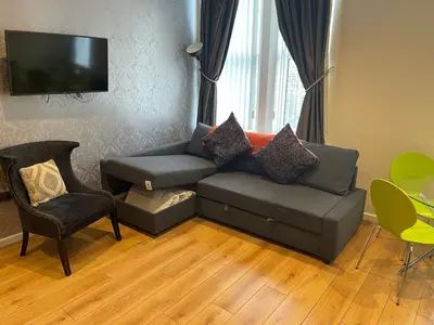 a living room with a couch and a chair at Contractor Bookers Liverpool City Centre in Liverpool