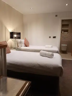 a hotel room with two beds and a bathroom at Contractor Bookers Liverpool City Centre in Liverpool