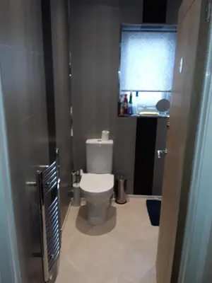 a small bathroom with a toilet and a window at Levens Terrace, Barrow Spa Therapy in Barrow in Furness