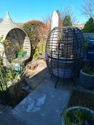 a garden with a bird cage and some plants at Levens Terrace, Barrow Spa Therapy in Barrow in Furness
