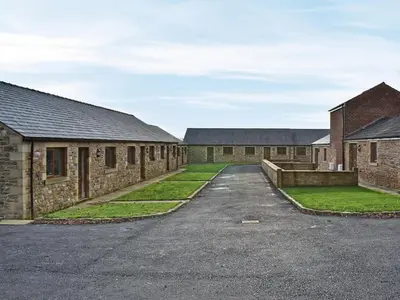 a row of brick buildings with a driveway at Six Dorchester Drive - Uk32627 in Inglewhite