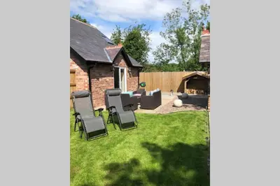 a yard with chairs and a backyard with a house at Dove Nest Cottage Blackpool Lytham St Annes in Lytham St Annes