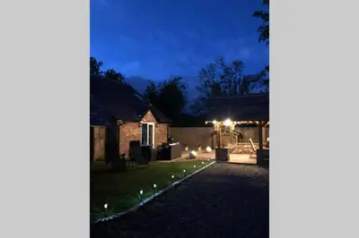 a backyard at night with lights on the grass at Dove Nest Cottage Blackpool Lytham St Annes in Lytham St Annes