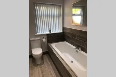 a bathroom with a tub and a toilet and a sink at Dove Nest Cottage Blackpool Lytham St Annes in Lytham St Annes