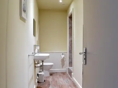a bathroom with a white toilet and a sink at Beachcomber Corner in Lytham St Annes