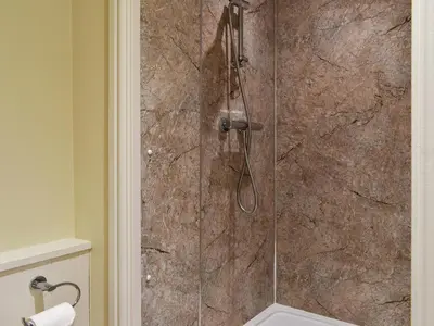 a bathroom with a shower with a glass door at Beachcomber Corner in Lytham St Annes