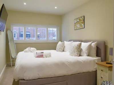 a bedroom with a large white bed with pillows at Beachcomber Corner in Lytham St Annes