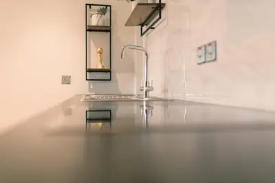 a white bathroom with a sink and a mirror at Sidemersey Livings- Convenient and Central 2-Bedroom Haven in L1, Secured Parking in Liverpool