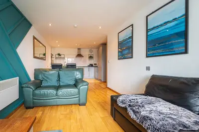 a living room with a couch and a table at Sidemersey Livings- Convenient and Central 2-Bedroom Haven in L1, Secured Parking in Liverpool