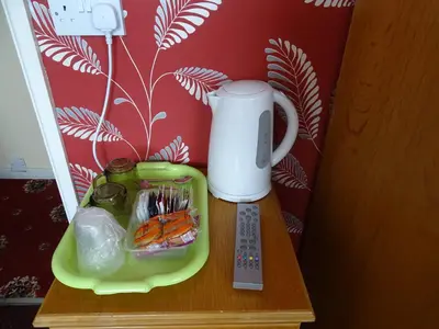 a table with a coffee maker and a tray of food at The Belvedere in Blackpool