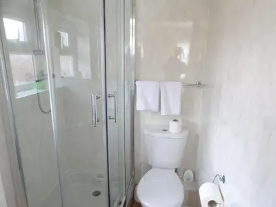 a bathroom with a toilet and a glass shower at The Belvedere in Blackpool