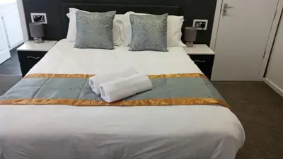 a large white bed with two towels on it at Hotel 33 in Blackpool