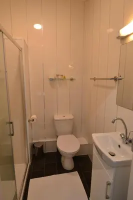 a small bathroom with a toilet and a sink at Hotel 33 in Blackpool