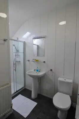 a bathroom with a toilet and a sink and a shower at Hotel 33 in Blackpool