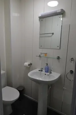 a white bathroom with a sink and a toilet at Hotel 33 in Blackpool