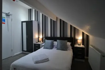 a bedroom with a large white bed with two night stands at Hotel 33 in Blackpool
