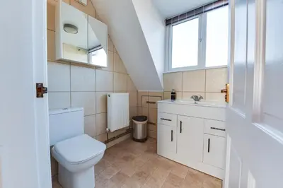 a bathroom with a toilet and a sink at 3 BR Home l Free Parking l 5 Guests l Garden l Long Stays l in Wigan