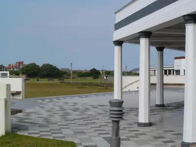 a parking lot with white columns and a sidewalk at Wavecrest Lodge in Fleetwood