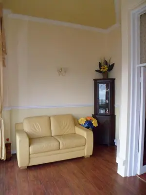 a living room with a couch and a table at Wavecrest Lodge in Fleetwood