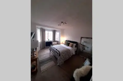 a living room with a bed and a television at Unique 2 Bedroom Apartment in the Ideal Location in Blackpool
