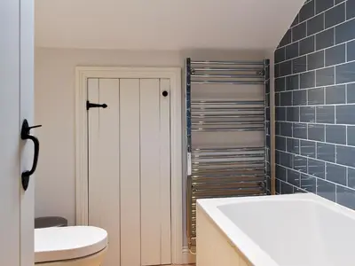 a bathroom with a toilet and a sink at The Burrow in Haverthwaite