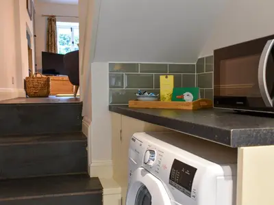a laundry room with a washer and dryer at The Burrow in Haverthwaite